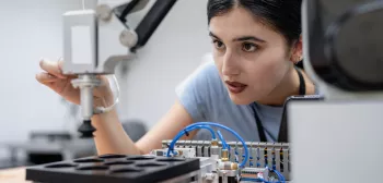 Female student working with AI in laboratory